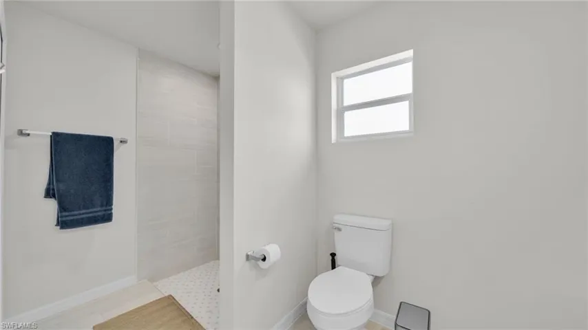 Bathroom with toilet and walk in shower