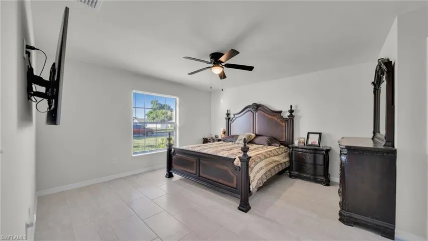 Bedroom with baseboards and ceiling fan