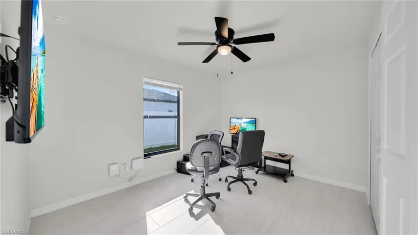 Office space with ceiling fan and light tile patterned floors