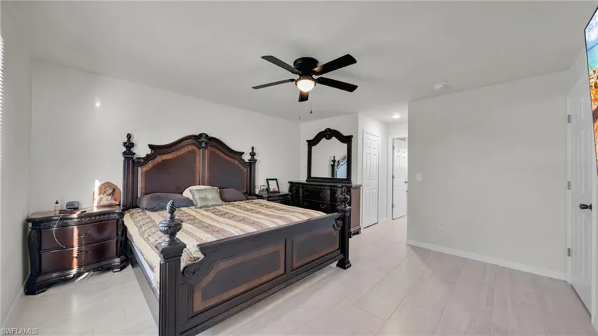 Bedroom featuring baseboards and ceiling fan
