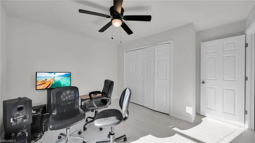 Office area with baseboards and a ceiling fan