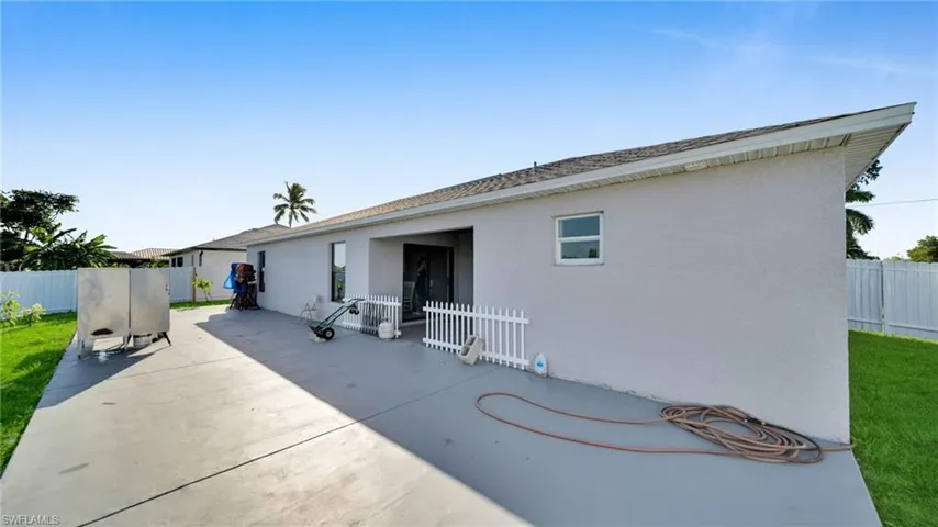 Back of house featuring a fenced backyard, stucco siding, a patio, and a shingled roof