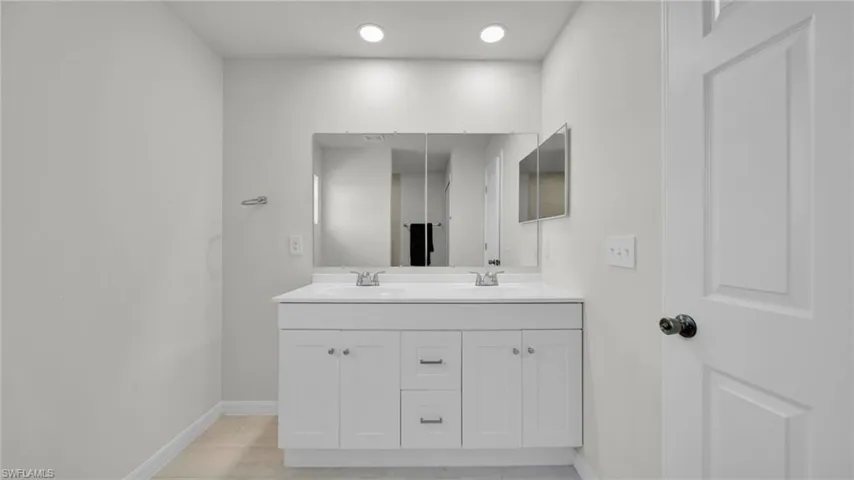 Bathroom with double vanity and recessed lighting