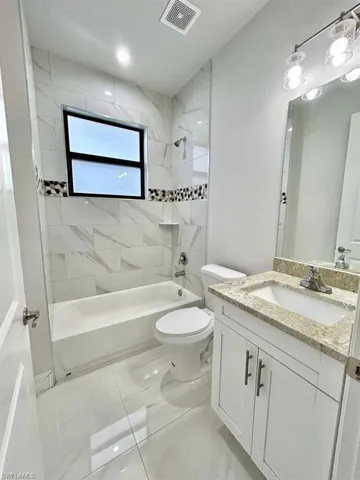 Full bath with vanity and bathtub / shower combination