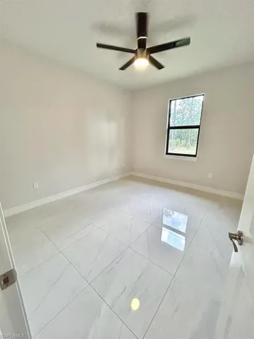 Spare room with baseboards and a textured ceiling