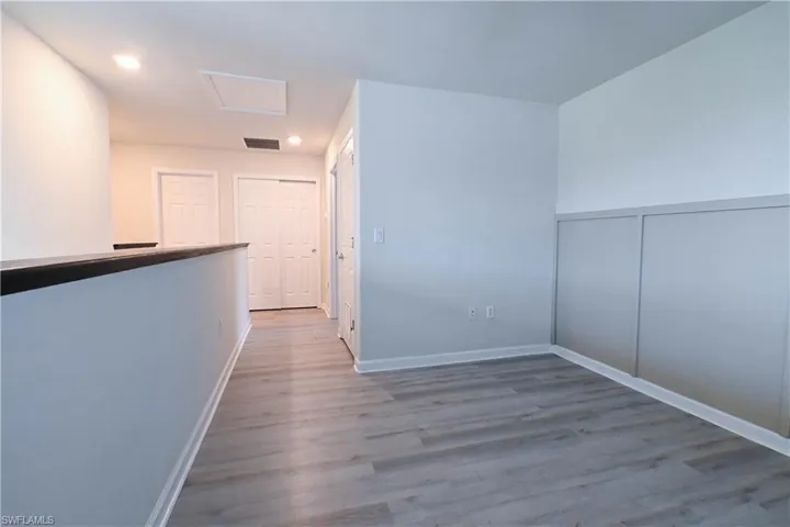 Corridor with light hardwood / wood-style floors