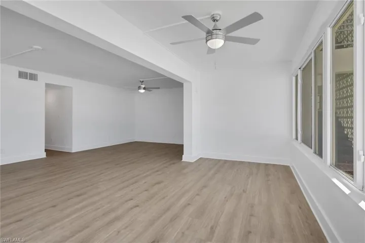 Empty room featuring ceiling fan and light wood finished floors