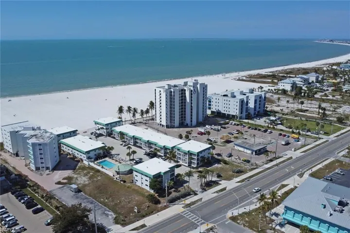 View of urban area with extended coastline and apartment complex / building