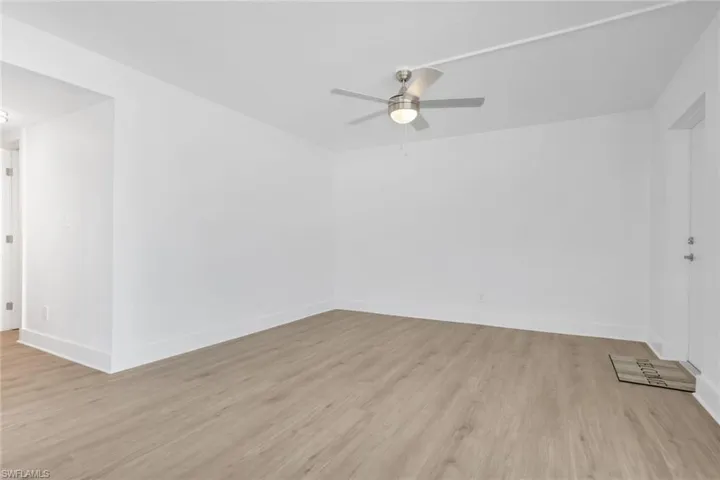 Spare room with light wood-type flooring and ceiling fan