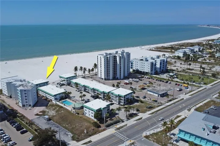 Aerial view of extended coastline and apartment complex / building