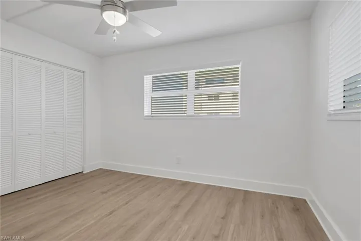 Unfurnished bedroom featuring a closet, light wood finished floors, and ceiling fan