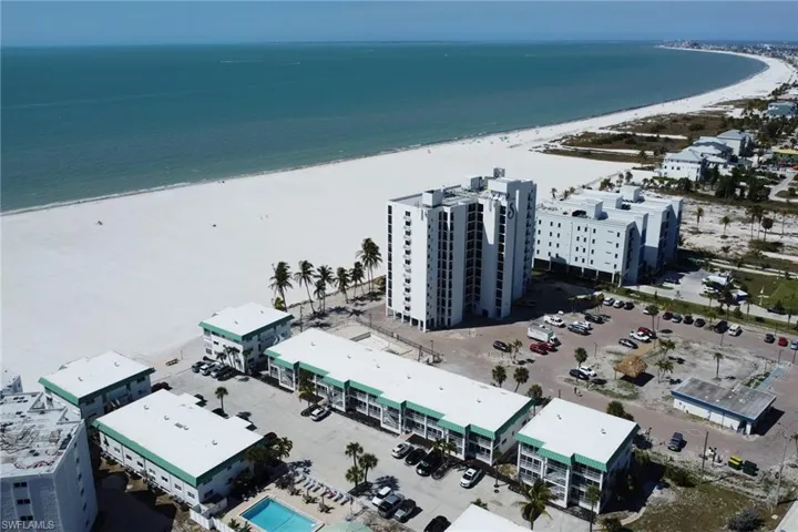 Bird's eye view of apartment complex / building and extended coastline