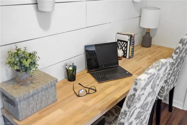 Home office with hardwood / wood-style flooring