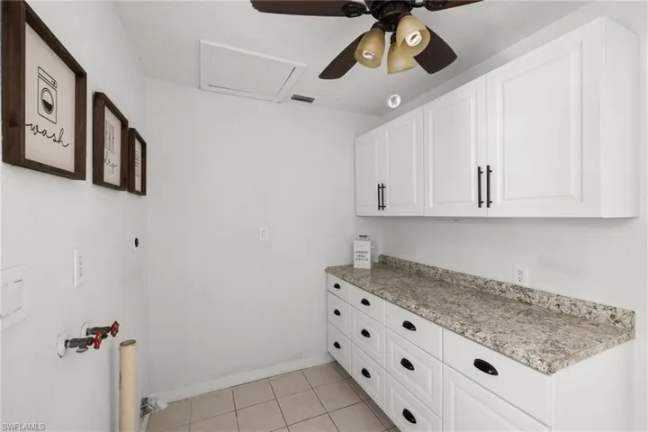 Washroom featuring ceiling fan and light tile patterned floors