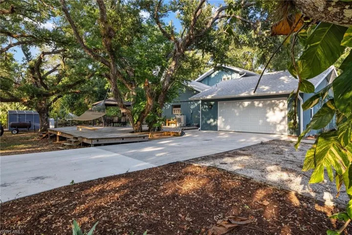 View of front of property with a deck and a garage