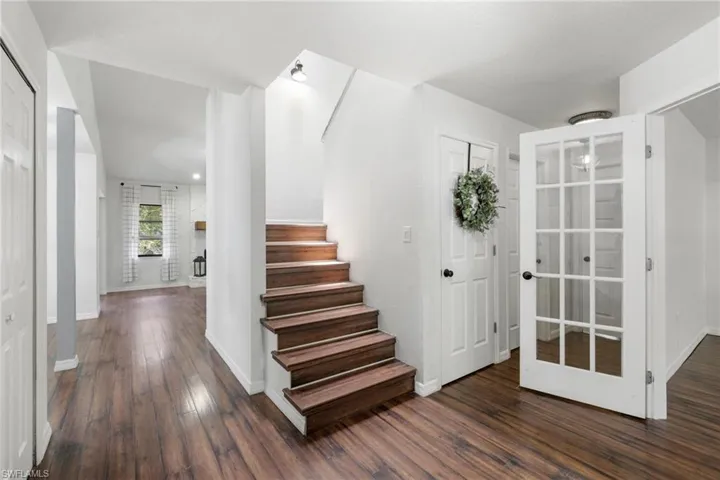 Stairway featuring hardwood / wood-style floors