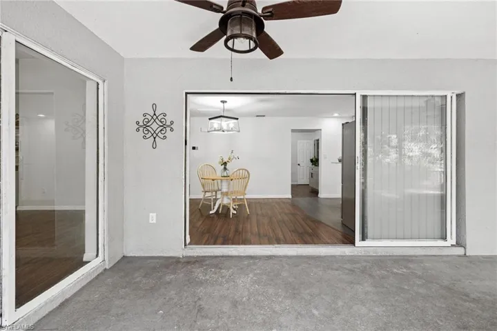 Unfurnished sunroom featuring ceiling fan