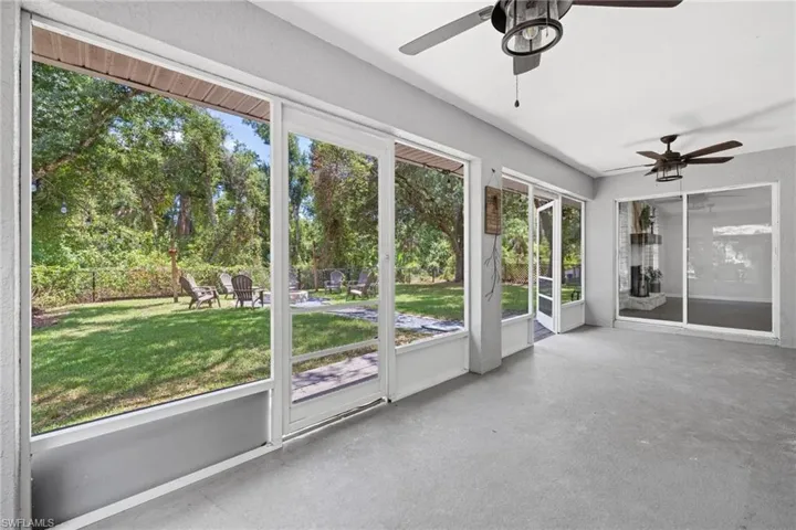Unfurnished sunroom featuring a wealth of natural light and ceiling fan
