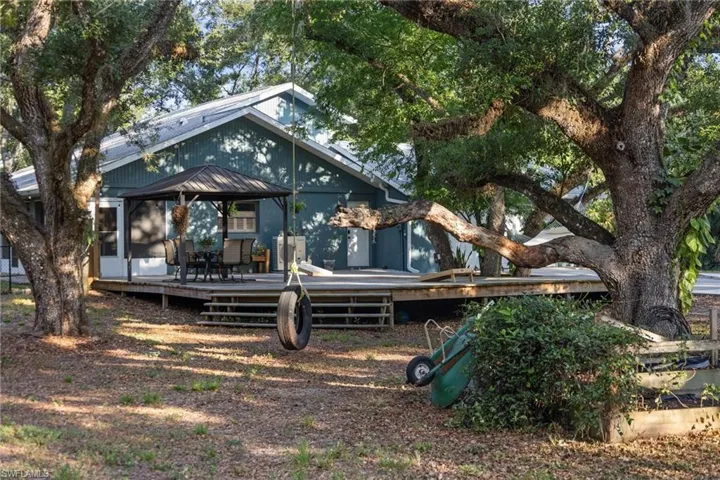 Back of house featuring a gazebo and a wooden deck