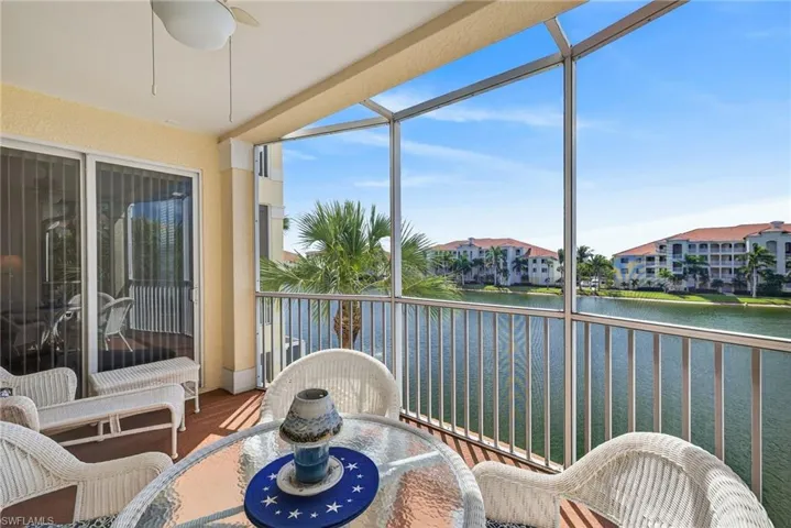 Sunroom with a water view and wood finished floors