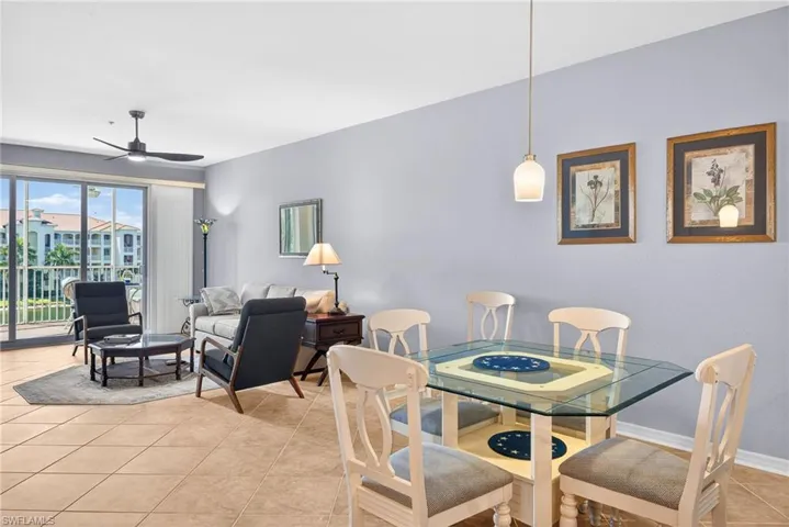 Dining room with ceiling fan and light tile patterned floors