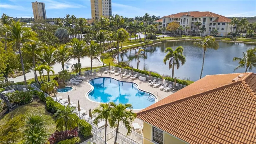 Community pool with a patio area and a water view