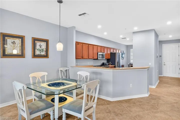 Dining room with recessed lighting and light tile patterned floors