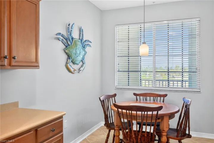 Dining room featuring light tile patterned floors and healthy amount of natural light