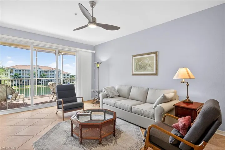 Living room with light tile patterned floors and ceiling fan