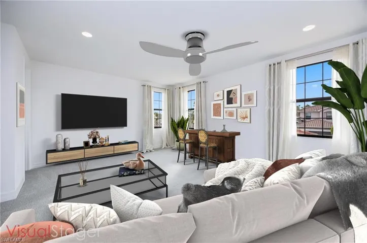Carpeted living room with ceiling fan