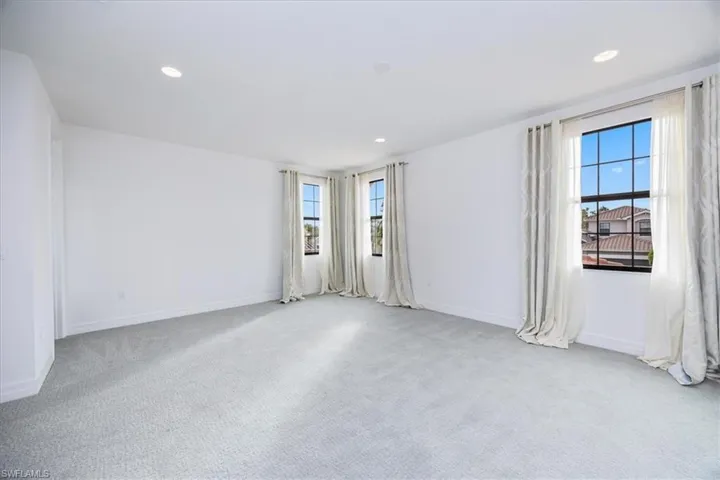 Carpeted spare room with plenty of natural light