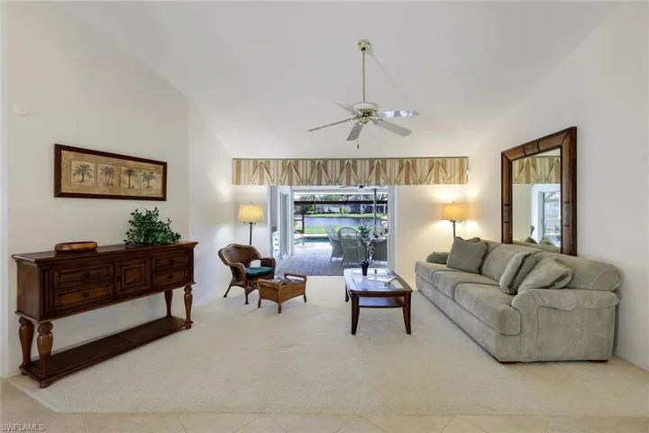 View of living room as you enter the front door. Pocket sliding glass doors to lanai.
