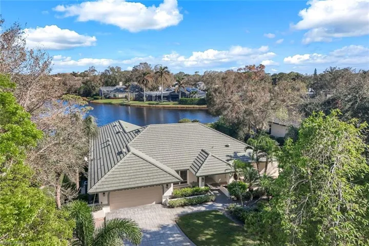Birds eye view of property with a water view