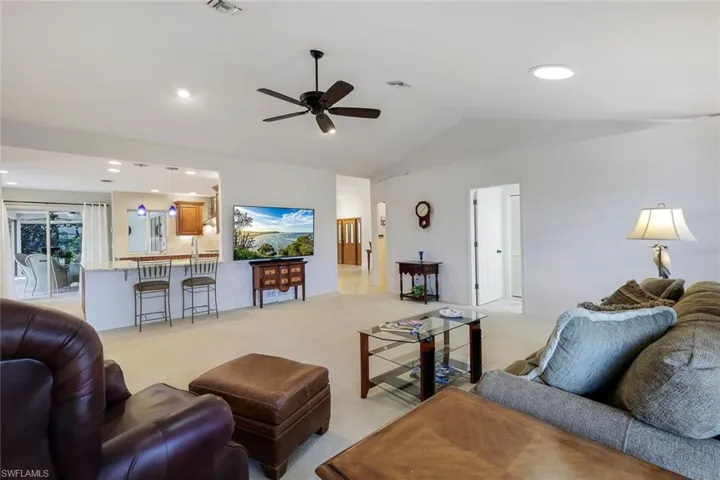 Carpeted family room and vaulted ceiling
