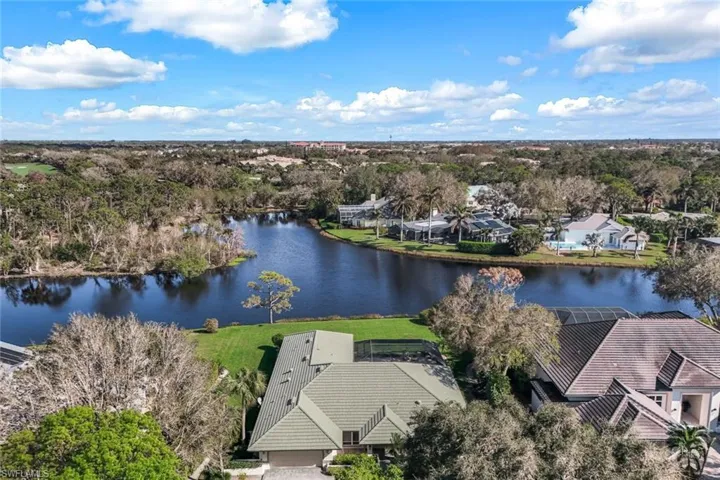 Birds eye view of property with lake and preserve view