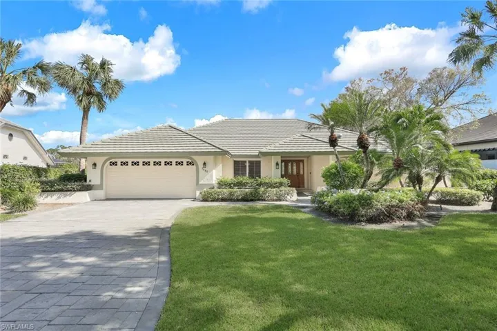 View of front of house with two car garage and a front yard