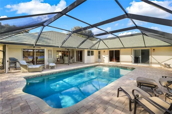 View of swimming pool with a lanai and a patio
