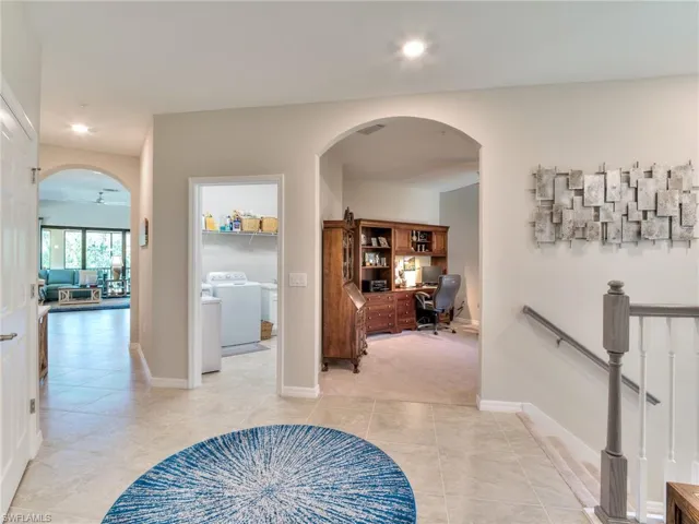 Hall with light tile flooring and washer / clothes dryer