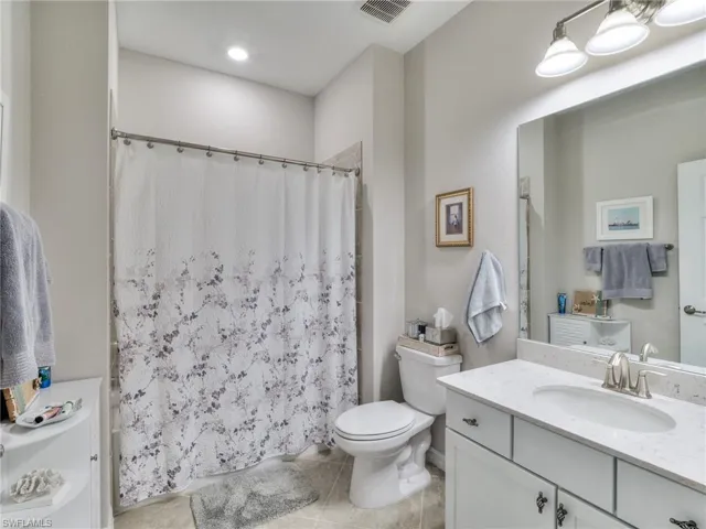Bathroom featuring tile flooring, vanity, and toilet