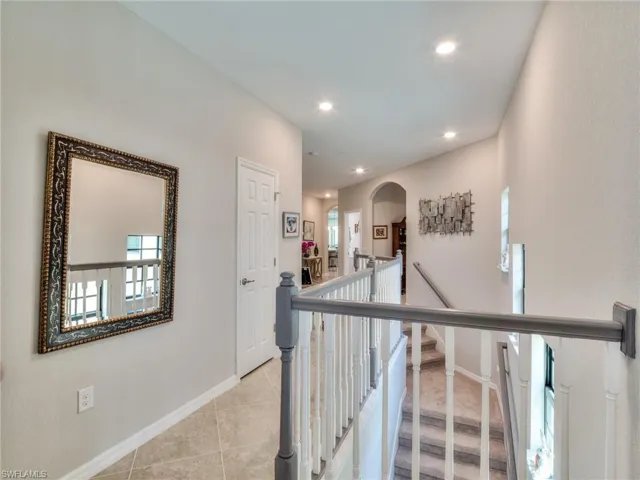 Corridor featuring light tile floors