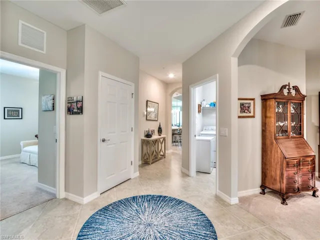 Hallway featuring light tile floors and washer / clothes dryer