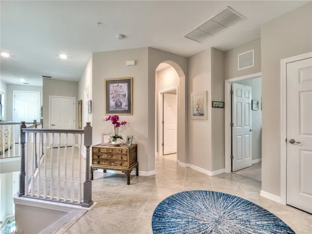 Hallway featuring light tile floors