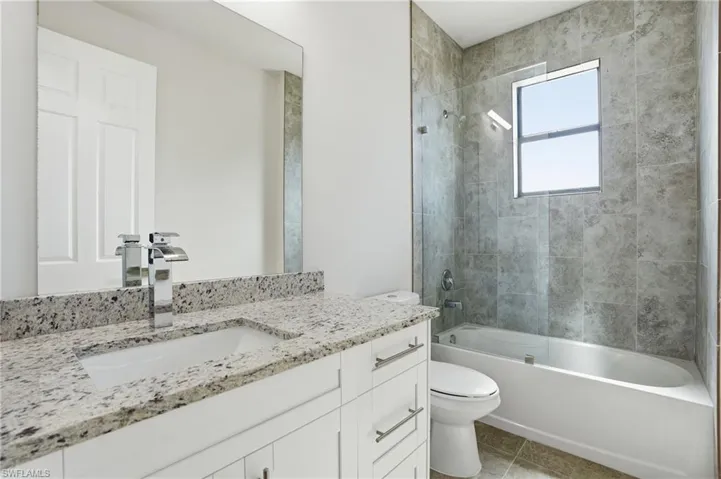 Bathroom featuring shower / bath combination and vanity