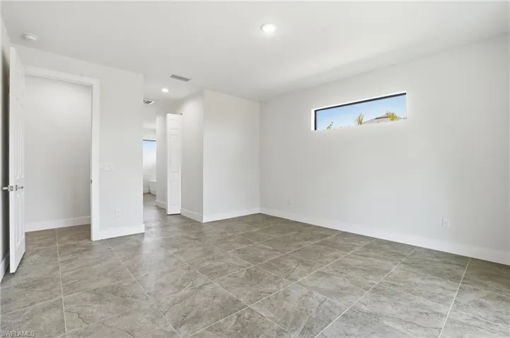 Empty room with recessed lighting and baseboards