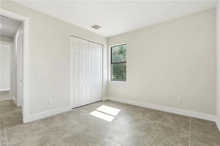 Unfurnished bedroom with baseboards and a closet
