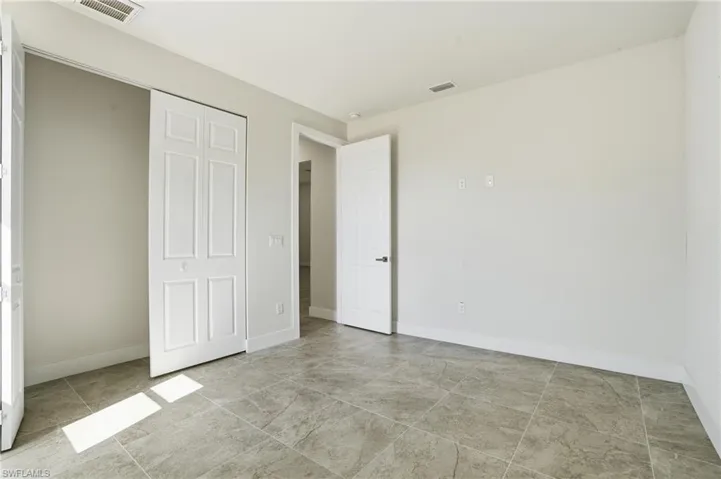 Unfurnished bedroom with a closet and baseboards