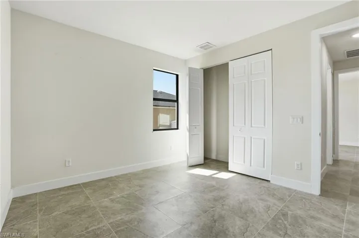 Unfurnished bedroom featuring baseboards and a closet