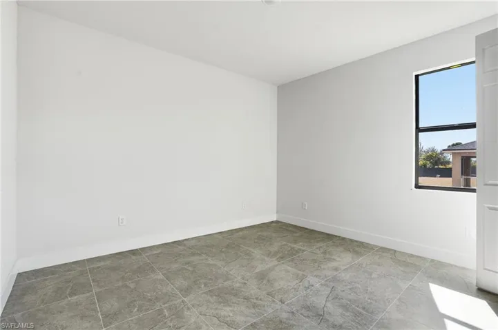Unfurnished room featuring baseboards