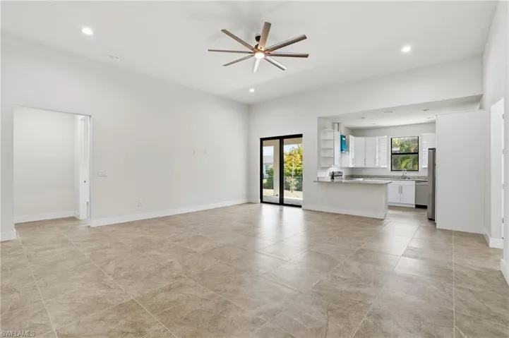 Unfurnished living room featuring a ceiling fan and recessed lighting