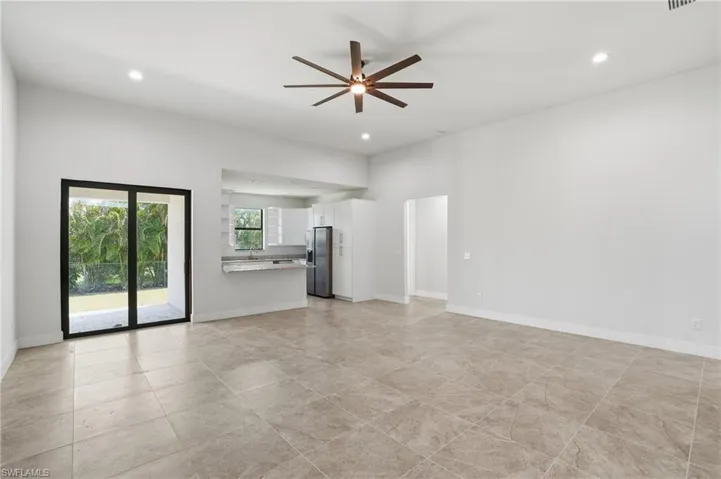 Unfurnished living room featuring ceiling fan and recessed lighting